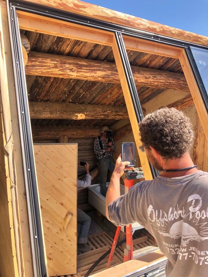 A photo of Kyle taking a photo of Josiah taking a photo of Matt filming all of us 
